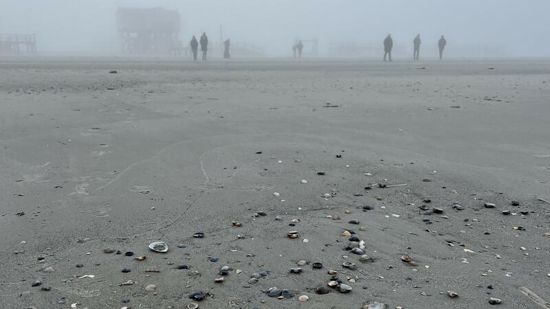Beach in fog with people and wooden building in the distance. © CWSS/Bostelmann Beach in fog with people and wooden building in the distance. © CWSS/Bostelmann